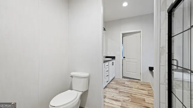a bathroom with a toilet and a shower
