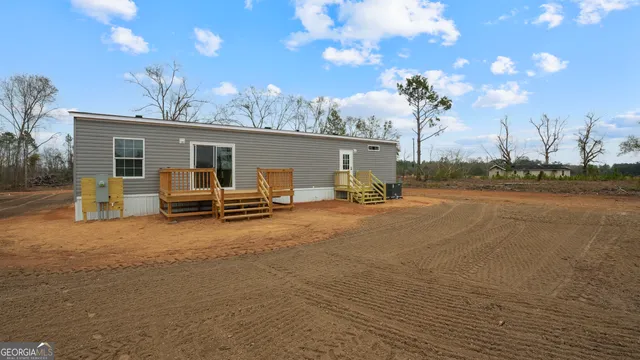 a view of a patio with table and chairs under an umbrella with wooden floor