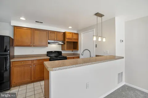 a kitchen with a sink appliances and cabinets