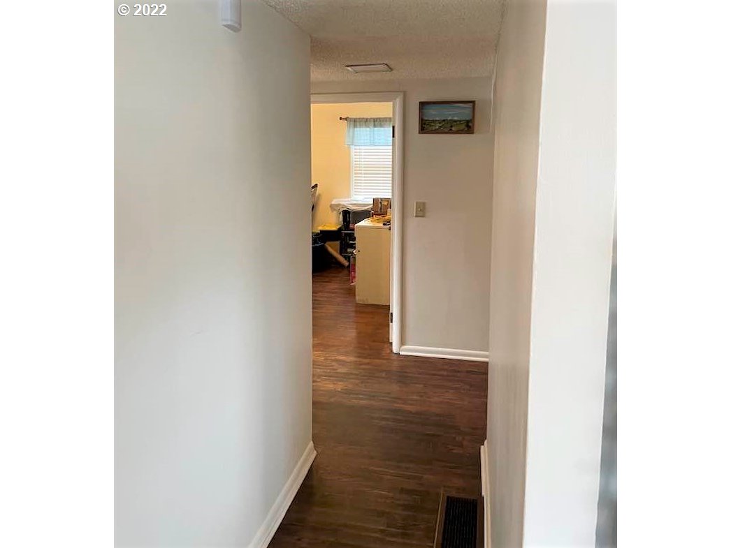 819 Southwest 7th Street Pendleton, OR 97801 - Photo 11 of 17 a view of a hallway with wooden floor