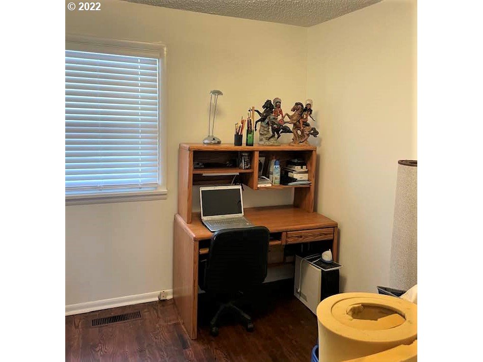 819 Southwest 7th Street Pendleton, OR 97801 - Photo 17 of 17 a view of a workspace with furniture and wooden floor