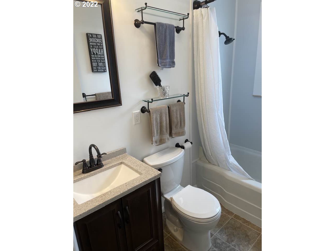 819 Southwest 7th Street Pendleton, OR 97801 - Photo 5 of 17 a bathroom with a granite countertop toilet sink and mirror