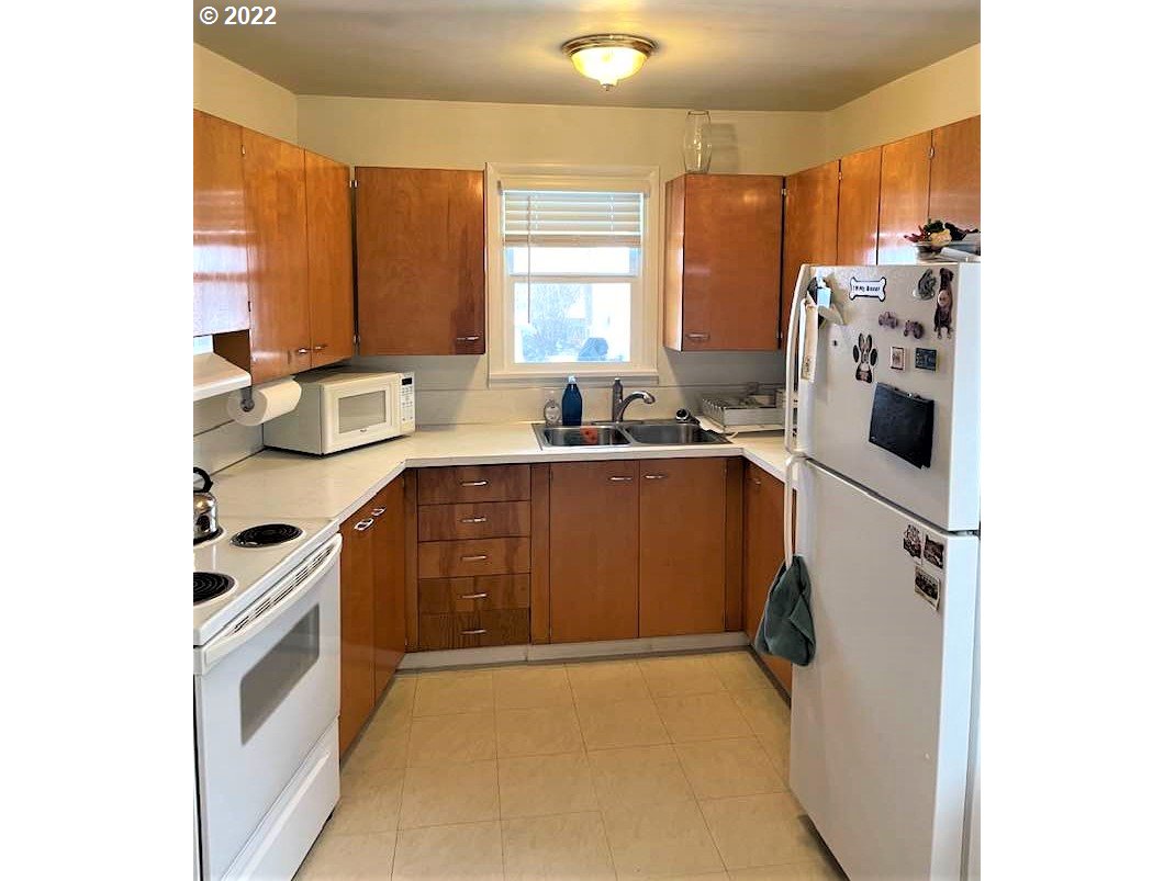 819 Southwest 7th Street Pendleton, OR 97801 - Photo 7 of 17 a kitchen with a sink appliances and cabinets