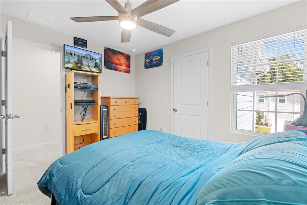 12003 Grizzly Lane New Port Richey, FL 34654 - Photo 34 of 43 a bedroom with a bed and wooden floor