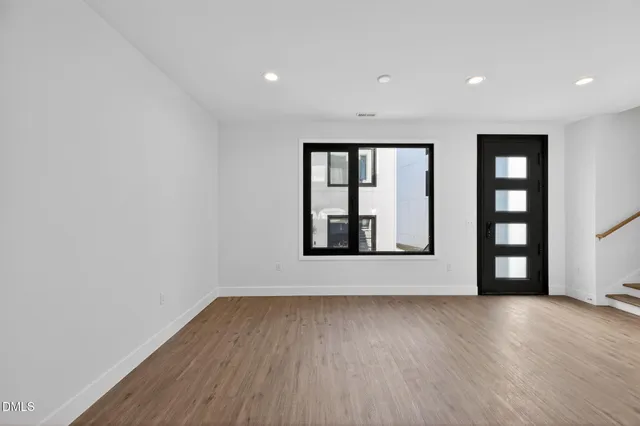 a kitchen with granite countertop white cabinets and black appliances