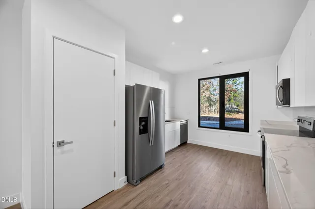 an empty room with wooden floor and closet