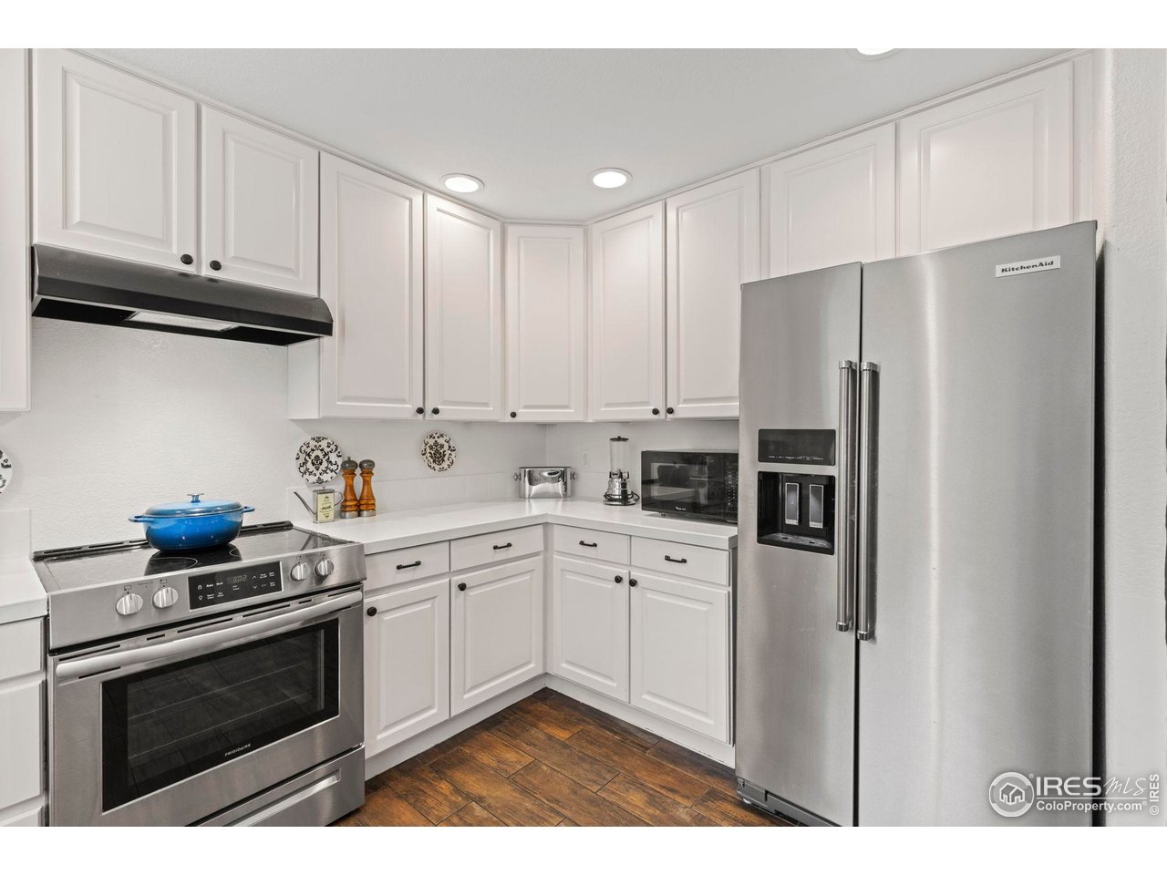 7271 Irwin Court Fort Collins, CO 80528 - Photo 14 of 49 a kitchen with stainless steel appliances granite countertop a refrigerator sink and cabinets