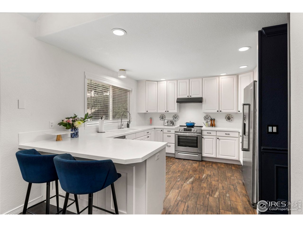 7271 Irwin Court Fort Collins, CO 80528 - Photo 16 of 49 a kitchen with a sink and chairs