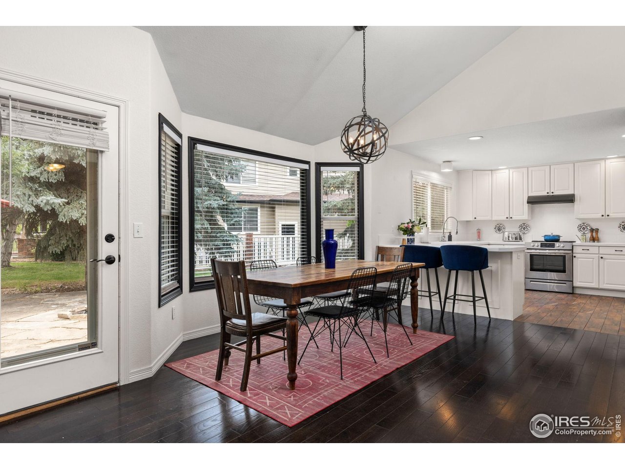 7271 Irwin Court Fort Collins, CO 80528 - Photo 17 of 49 a view of a dining room with furniture window and wooden floor