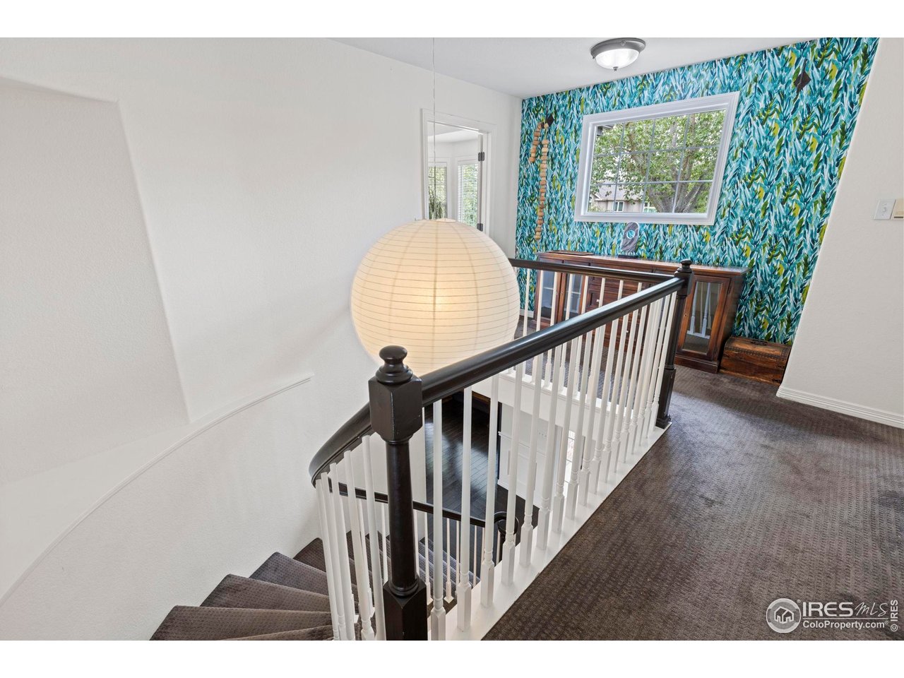 7271 Irwin Court Fort Collins, CO 80528 - Photo 24 of 49 a view of staircase with railing and white walls