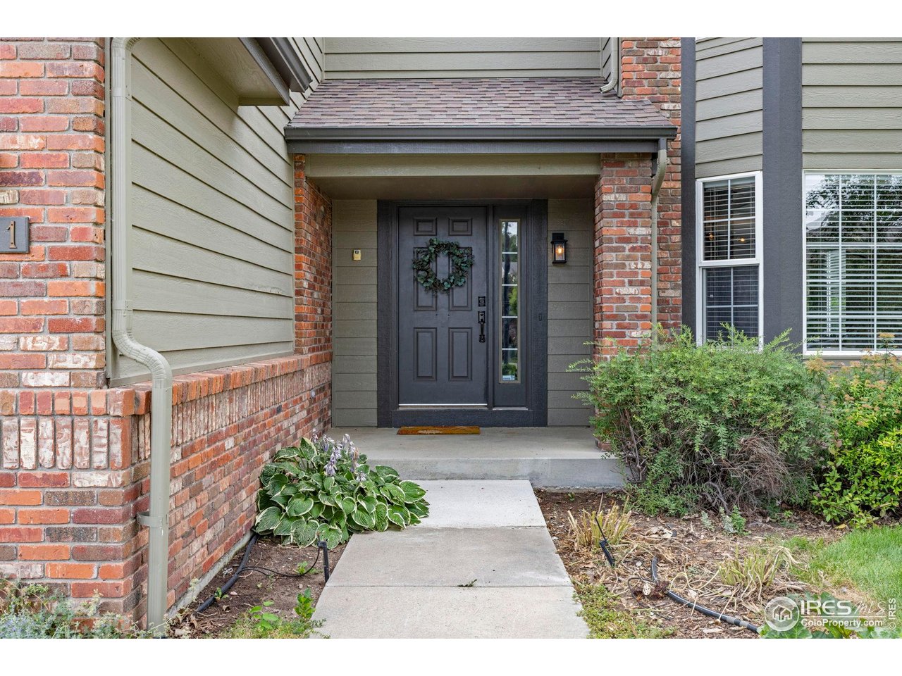 7271 Irwin Court Fort Collins, CO 80528 - Photo 7 of 49 a view of a brick house with potted plants