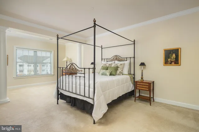 a bed sitting in a bedroom next to a window