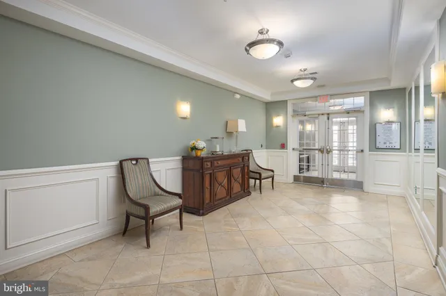 a view of a room with lounge chair and windows