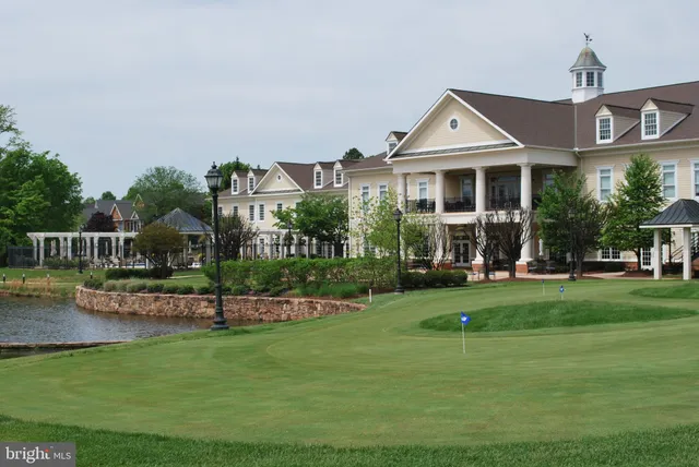 a front view of a house with a yard table and chairs