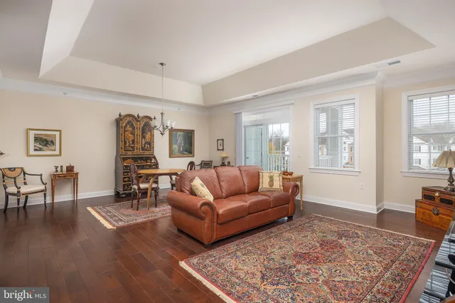 a living room with furniture wooden floor and a window