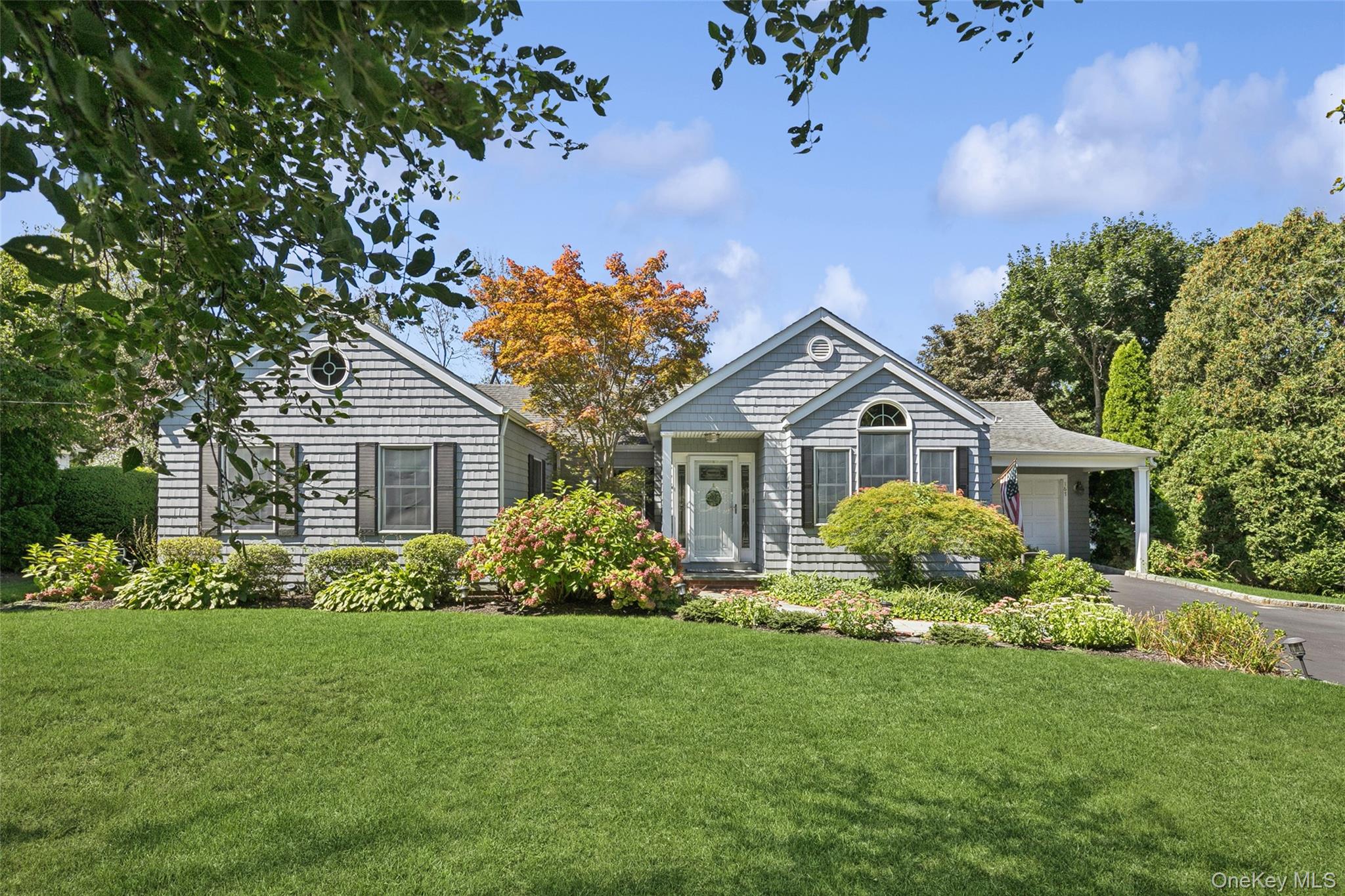 a front view of house with yard and green space