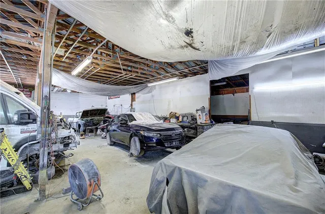 a living room with furniture a flat screen tv and a window