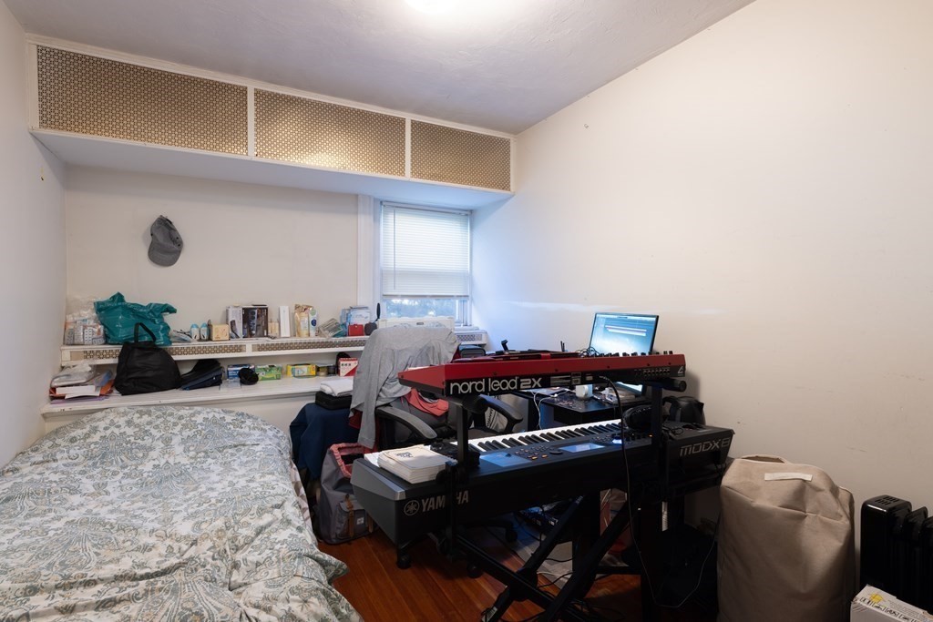 16 Garrison Road, Unit 7 Brookline, MA 02445 - Photo 8 of 9 a room with furniture a rug and a window