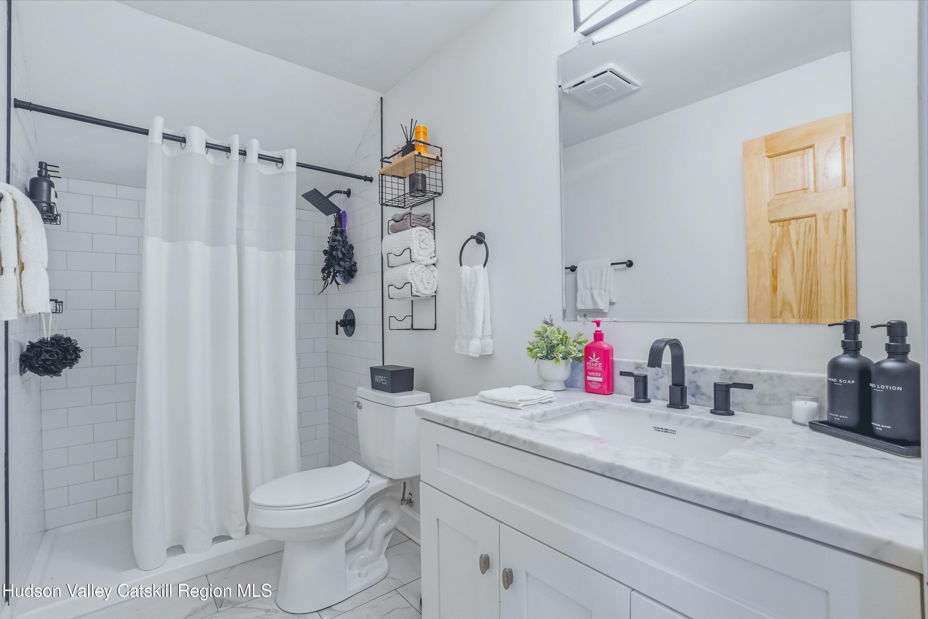 757 Taborton Road Sand Lake, NY 12153 - Photo 22 of 32 a bathroom with a sink toilet and shower