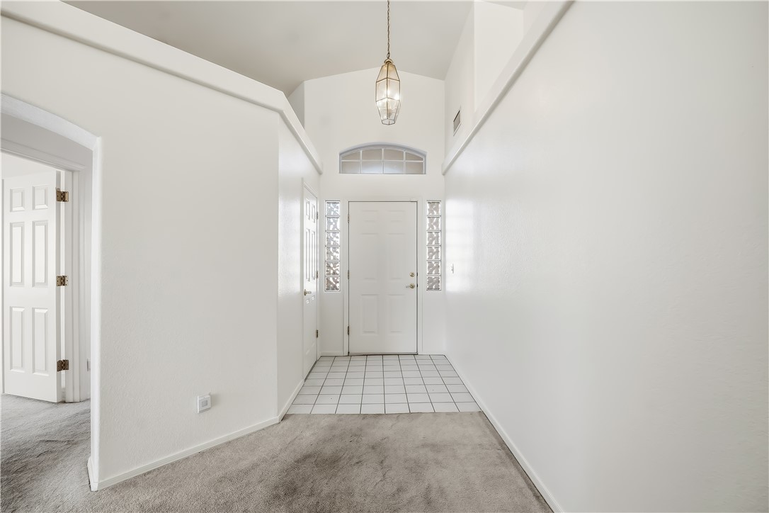 2853 Winchester Road Bullhead City, AZ 86442 - Photo 4 of 40 Entryway featuring a white door, arched transom window, and decorative glass block sidelights