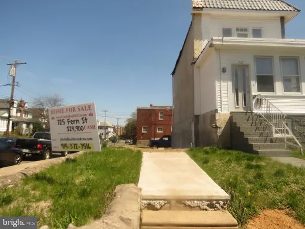 a view of an white house with a yard