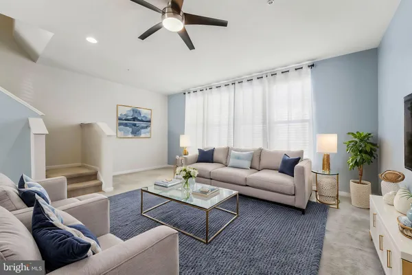 a living room with furniture and a large window