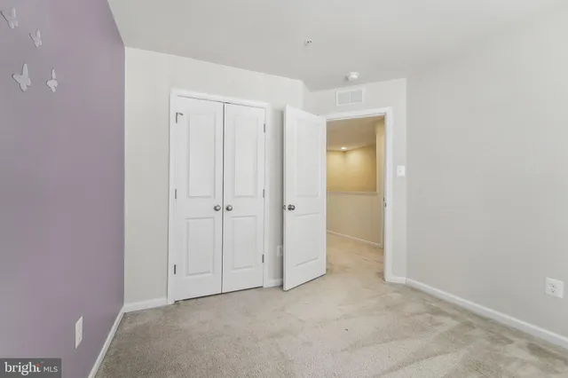 an empty room with a bathroom and a sink