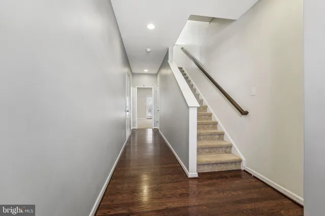 a view of entryway and hall with wooden floor