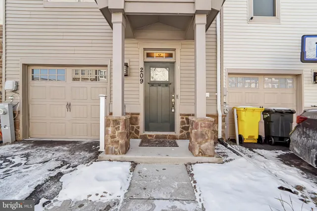 front view of a brick house with large windows