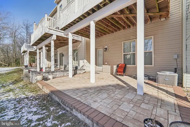 a view of a patio with dining table and chairs with wooden floor