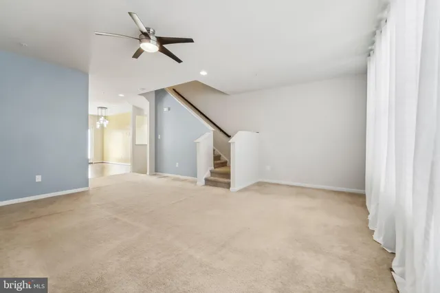 a view of an empty room with a ceiling fan