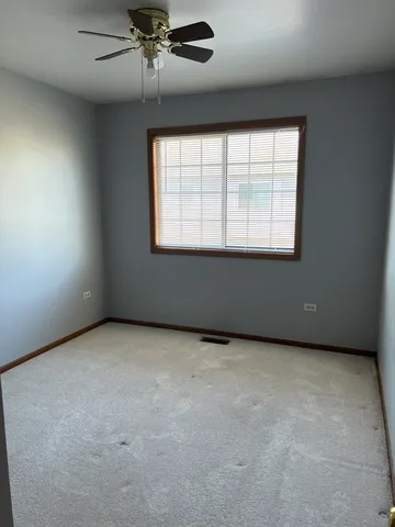 an empty room with a empty space and windows