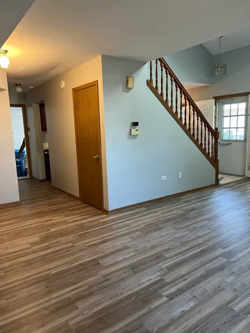 a view of an entryway with wooden floor