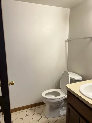 a white toilet sitting next to a shower