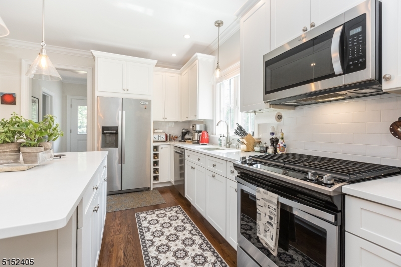 429 Green Village Road, Unit 2 Green Village, NJ 07935 - Photo 12 of 26 a kitchen with stainless steel appliances a stove a microwave a sink and white cabinets