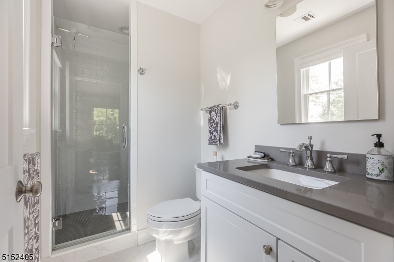429 Green Village Road, Unit 2 Green Village, NJ 07935 - Photo 22 of 26 a bathroom with a granite countertop sink a toilet and shower