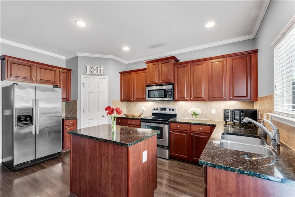 3039 Liberty Way Northwest Atlanta, GA 30318 - Photo 12 of 43 a kitchen with stainless steel appliances granite countertop a stove a sink dishwasher a refrigerator and a microwave