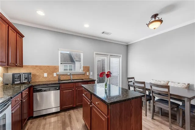 a kitchen with a sink stove and cabinets
