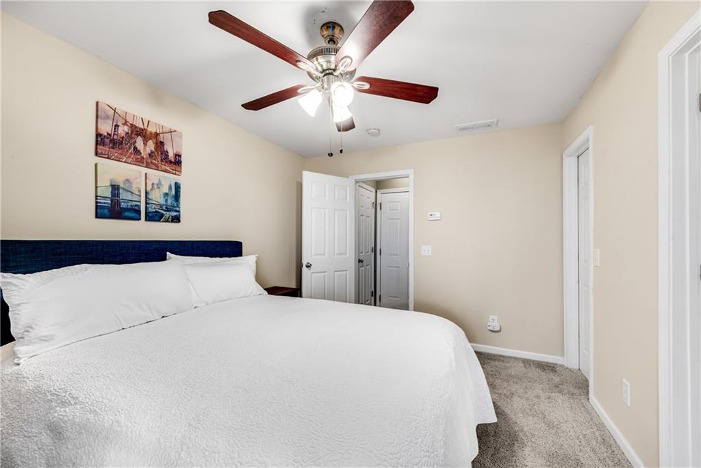 3039 Liberty Way Northwest Atlanta, GA 30318 - Photo 34 of 43 a bedroom with a large bed and a chandelier