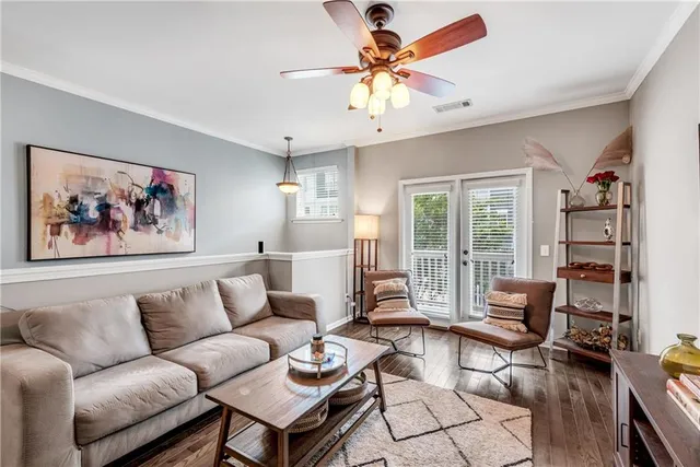 a living room with furniture a flat screen tv and a large window