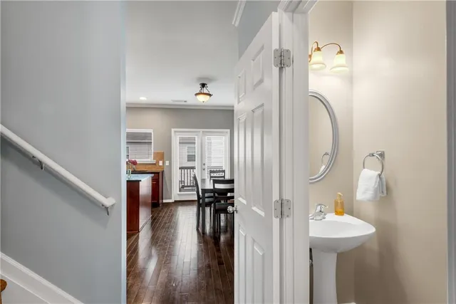 a view of a hallway with wooden floor and entryway