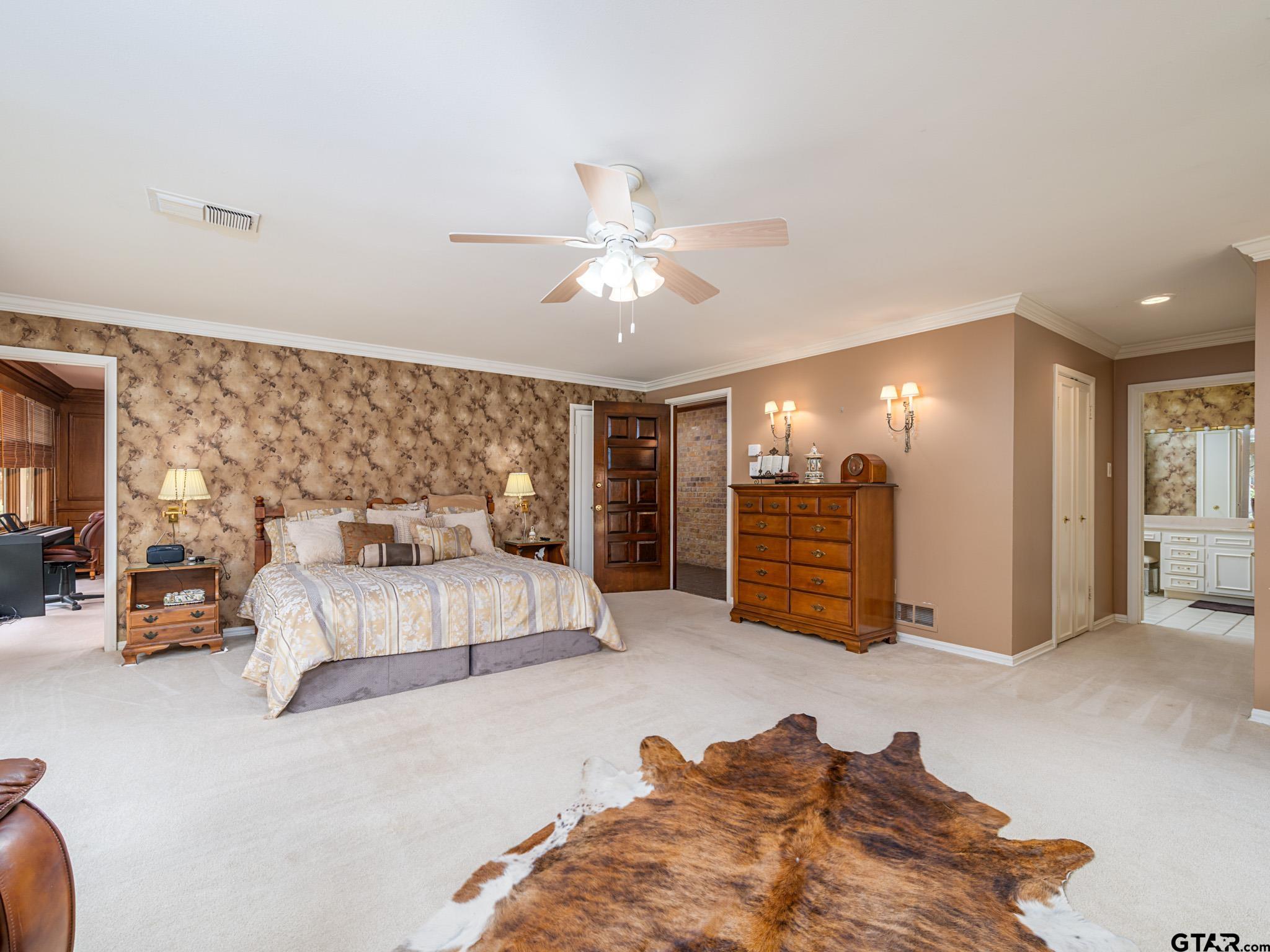 16611 Old Noonday Road Tyler, TX 75703 - Photo 13 of 46 a spacious bedroom with a bed and ceiling fan
