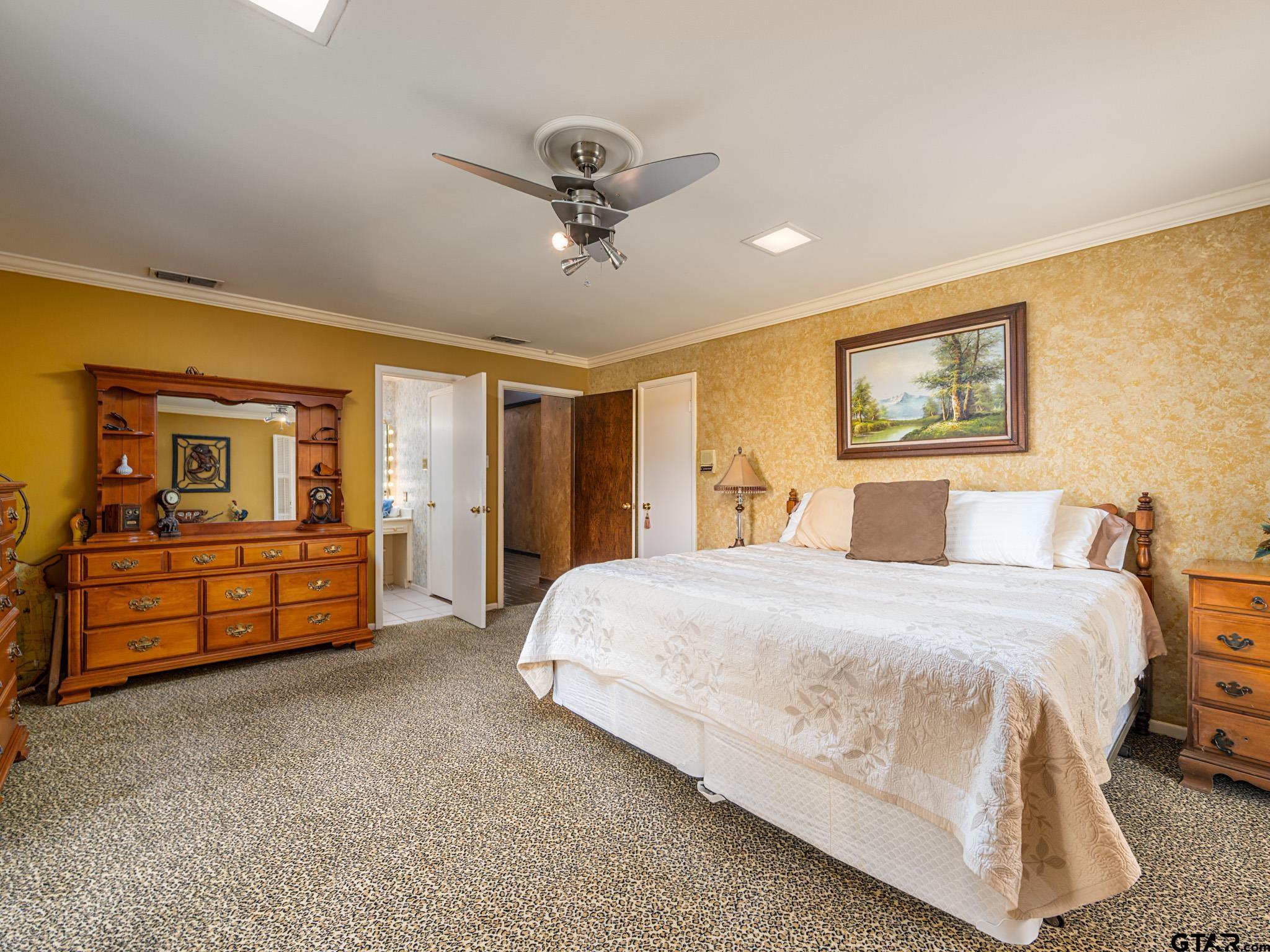 16611 Old Noonday Road Tyler, TX 75703 - Photo 19 of 46 a spacious bedroom with a bed and dresser