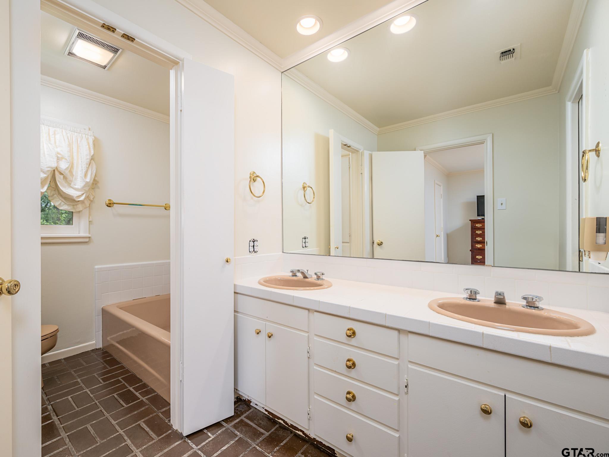 16611 Old Noonday Road Tyler, TX 75703 - Photo 23 of 46 a spacious bathroom with a double vanity sink a mirror and a