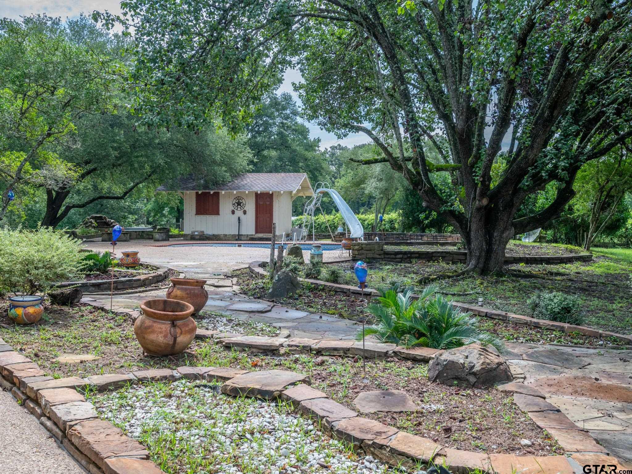 16611 Old Noonday Road Tyler, TX 75703 - Photo 26 of 46 a front view of a house with garden