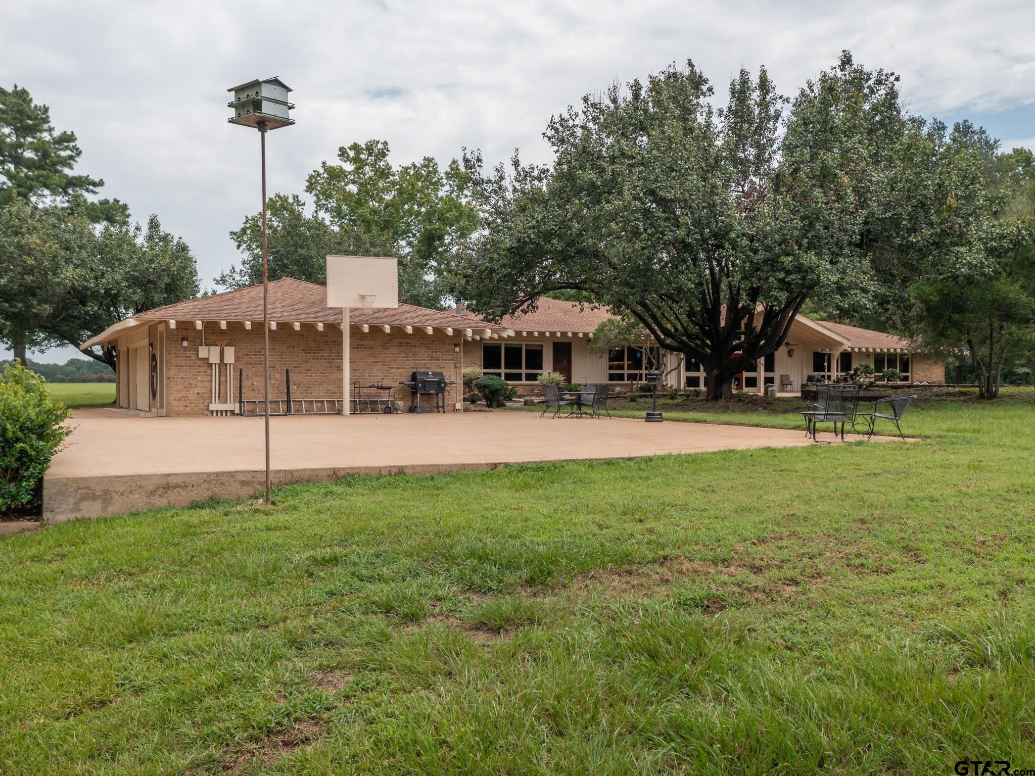 16611 Old Noonday Road Tyler, TX 75703 - Photo 28 of 46 a backyard of a house with table and chairs