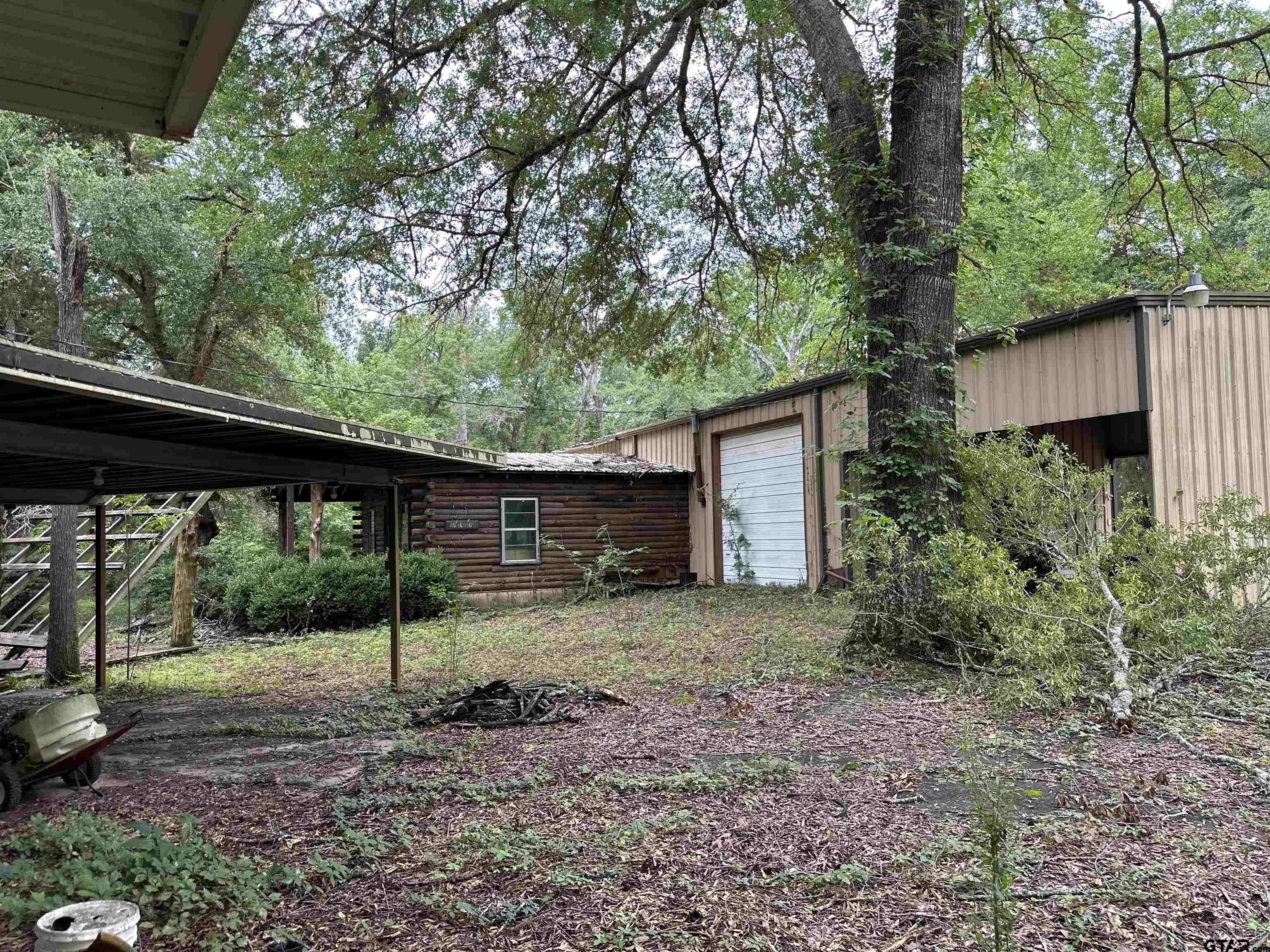 16611 Old Noonday Road Tyler, TX 75703 - Photo 41 of 46 a view of a backyard with large trees and plants