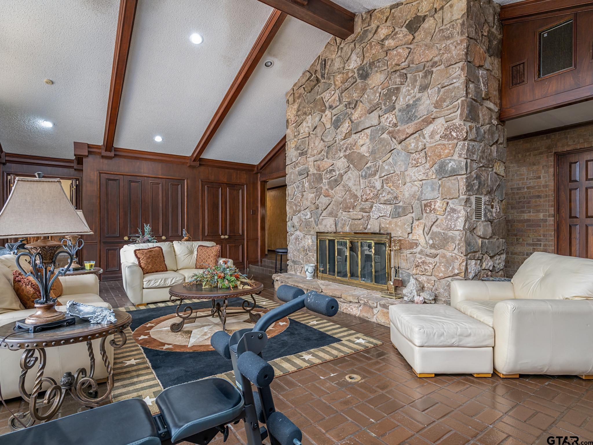 16611 Old Noonday Road Tyler, TX 75703 - Photo 7 of 46 a living room with furniture a fireplace and a flat screen tv