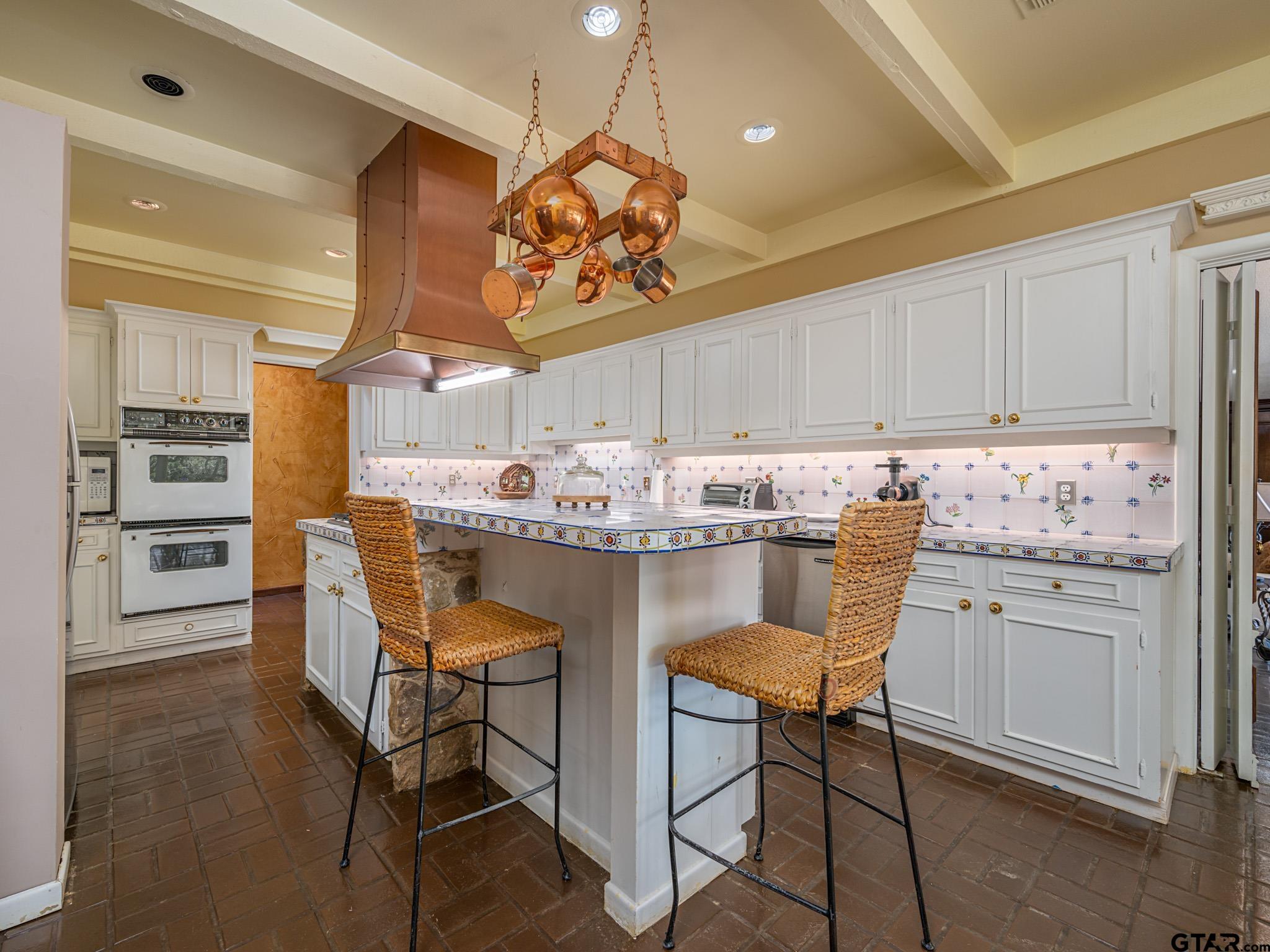 16611 Old Noonday Road Tyler, TX 75703 - Photo 9 of 46 a kitchen with a table chairs and white cabinets