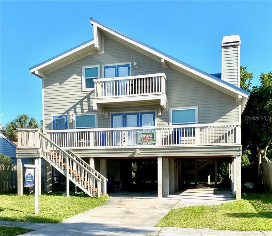 544 72nd Avenue St. Pete Beach, FL 33706 - Photo 1 of 1 a view of a house with a yard and deck
